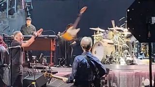 Bruce Springsteen throwing an electric guitar