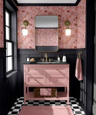 Raspberry pink bathroom with floral wallpaper and black and white chequered floor tiles