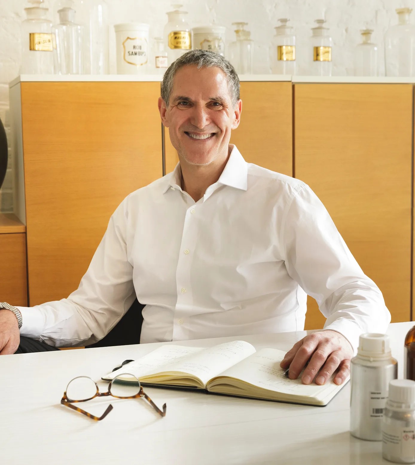 A man, Jon Bresler, sits in front of an open journal.