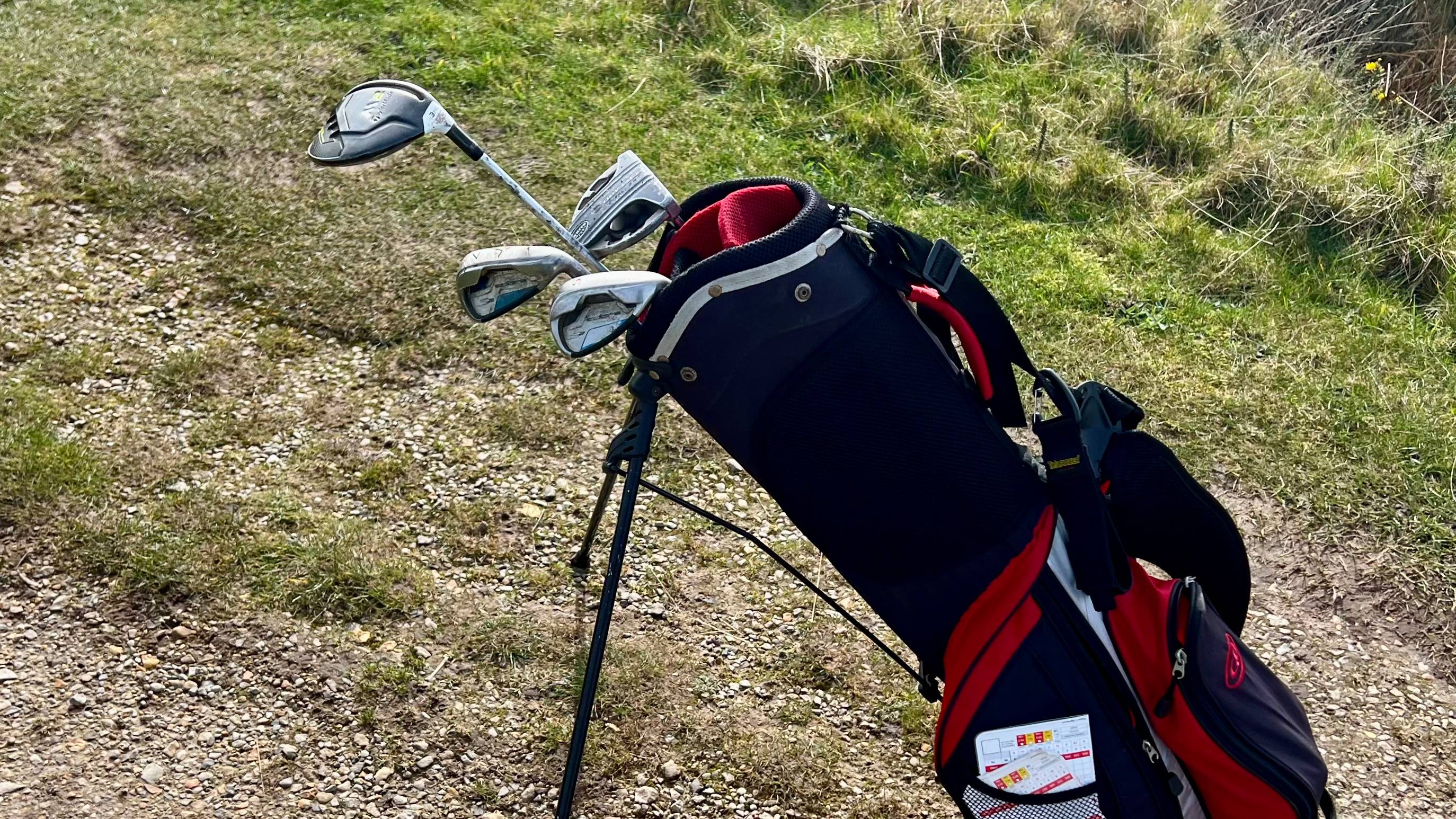Golf bag showing just a few clubs