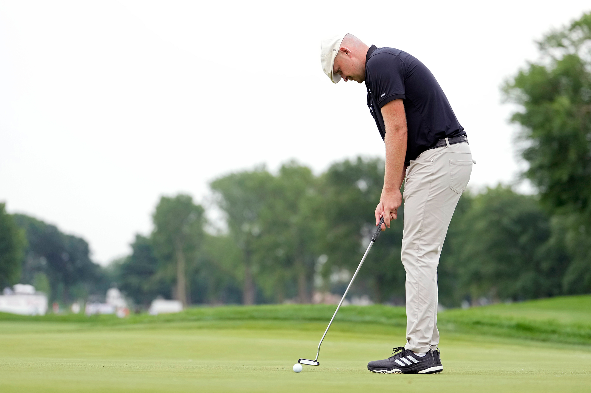 Harry Hall hitting a putt at a PGA Tour event
