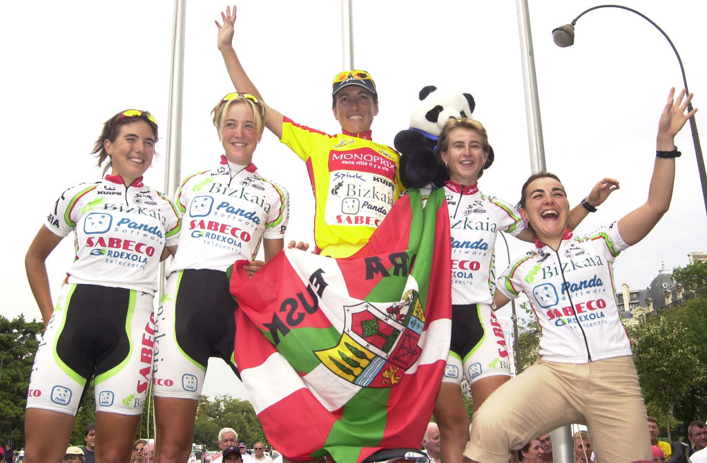 Spains Joane Somarriba celebrates with her teammate of Bizkaia on the podium of the Grande Boucle women's tour de France cycling race 17 August 2003 in Paris after winning the event for the third time AFP PHOTO JEANLUC LAMAERE Photo by JEANLUC LAMAERE AFP Photo by JEANLUC LAMAEREAFP via Getty Images