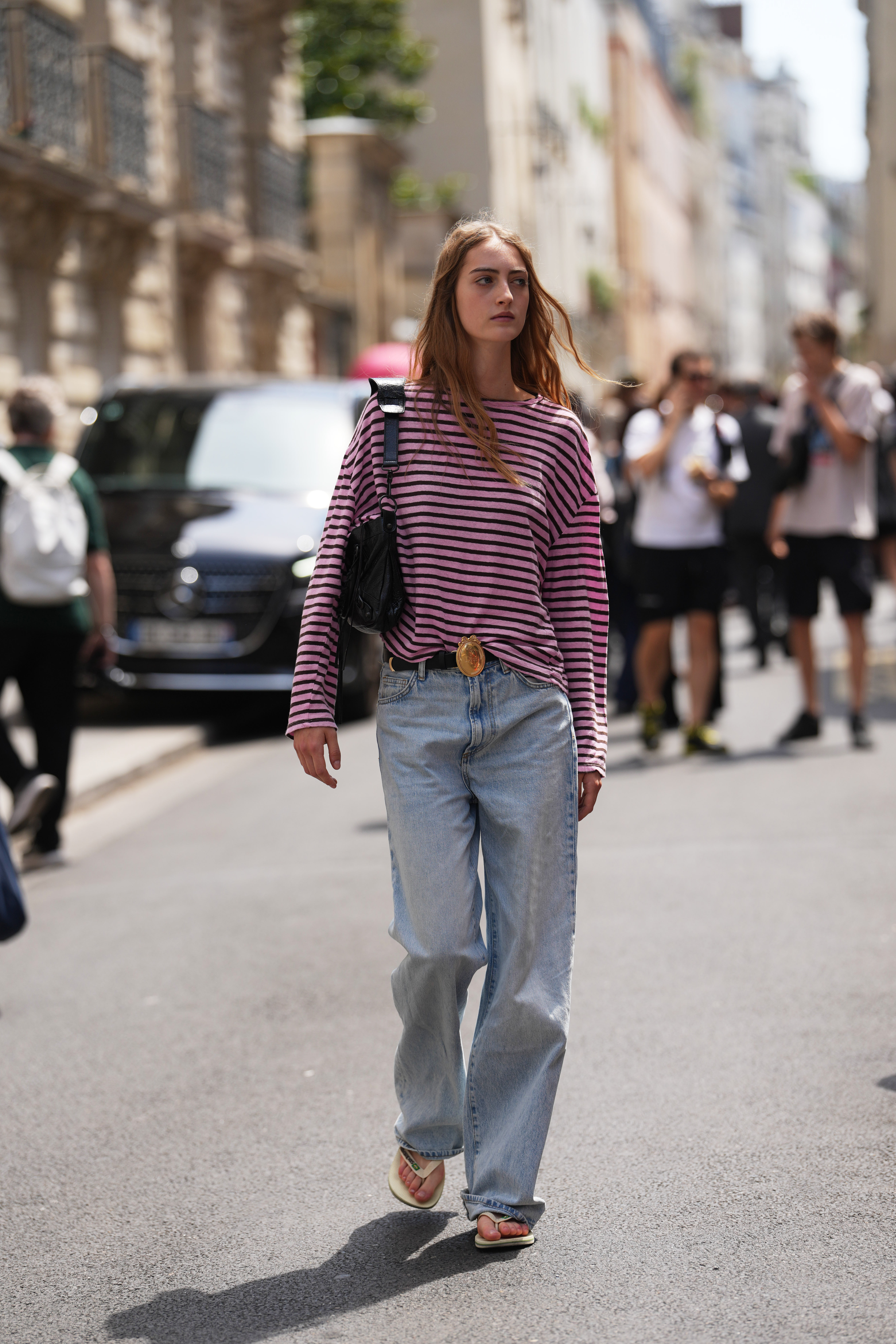 a woman wearing a striped t-shirt and jeans