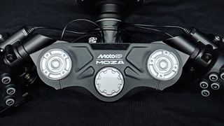 A close up of the Moza Racing MotoGP handlebars showing the central controls, the Moza and MotoGP logos and buttons.