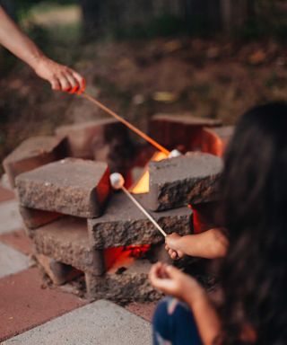 making s'mores around fire pit