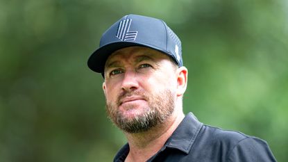 A close-up shot of Graeme McDowell with a black LIV Golf cap on