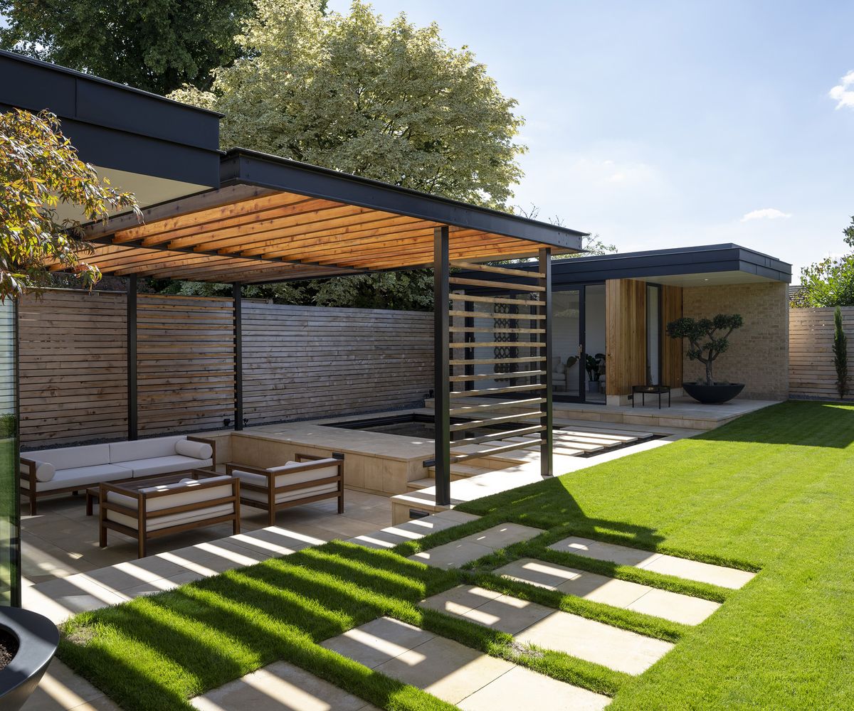 Sunken patio seating area with covered arbour and garden room