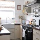 kitchen with gas stove microwave and teapot