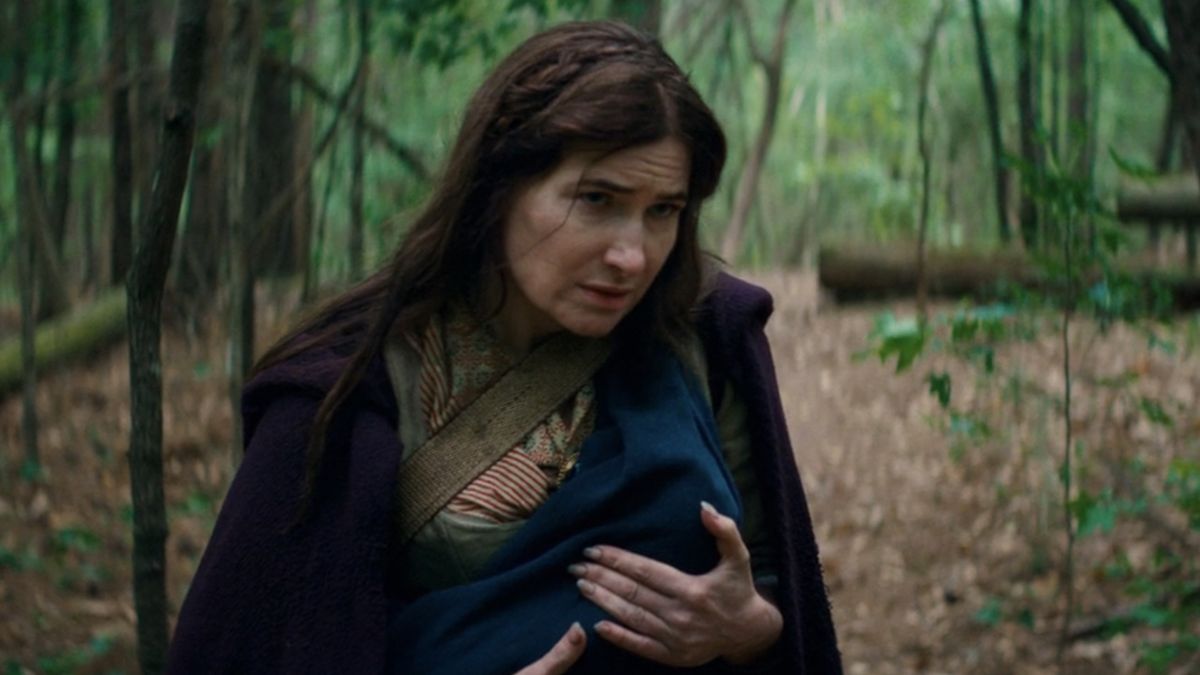 Agatha holding infant Nicholas Scratch in the woods on Agatha All Along finale