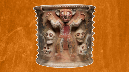 a ceramic urn with a person dressed like a jaguar surrounded by four human skulls