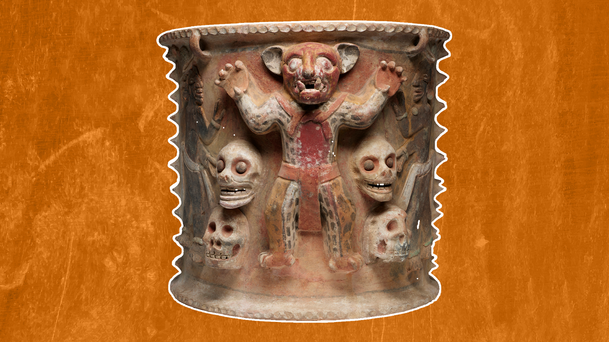 a ceramic urn with a person dressed like a jaguar surrounded by four human skulls