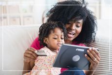mother and young daughter shopping on tablet with credit card