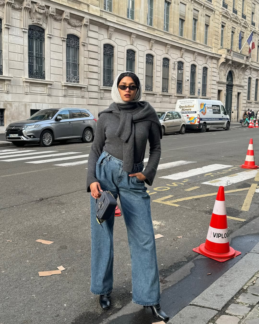 Influencer Lena Farl wearing a grey jumper, wide leg jeans and knitted hood.
