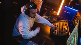 The new the closed-back HD 480 PRO headphones on a male mixer in a studio. 