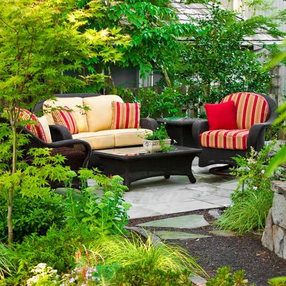 An outdoor seating area surrounded by greenery