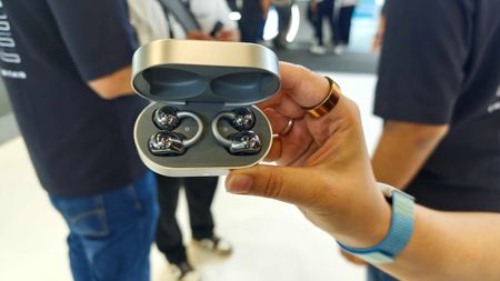 Noise Master Buds Open with Sound by Bose, held in a hand