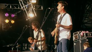 American alternative rock group Foo Fighters, performing on stage, 1998. Left to right: Nate Mendel, Dave Grohl and Franz Stahl.
