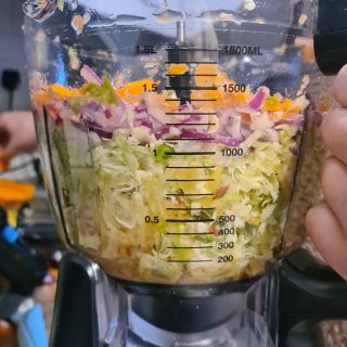 Side view of Ninja 3-in-1 Food Processor jug showing measurements and chopped vegetables inside