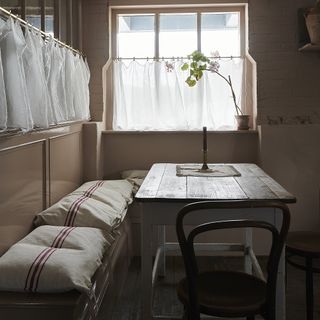 deVOL kitchen with light pink walls and cafe curtains on windows