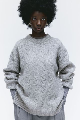 grey jumpers woman wearing oversized cable knit