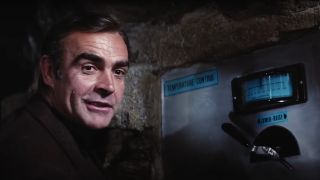 Sean Connery smirks in front of a control panel in Diamonds Are Forever.