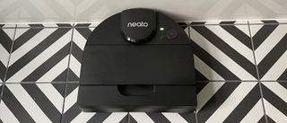 The Neato D9 on a black and white striped hard floor