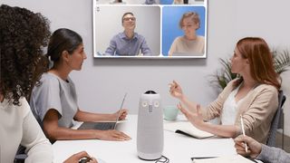 People in a business meeting using one of the best conference room webcams, the Meeting Owl Pro