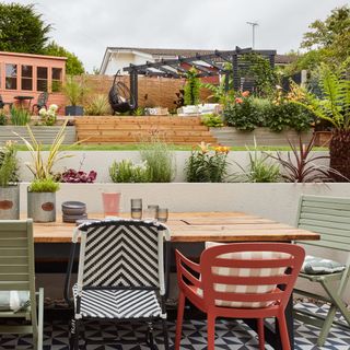 garden table and chairs on lower level to grass and decking area with furniture