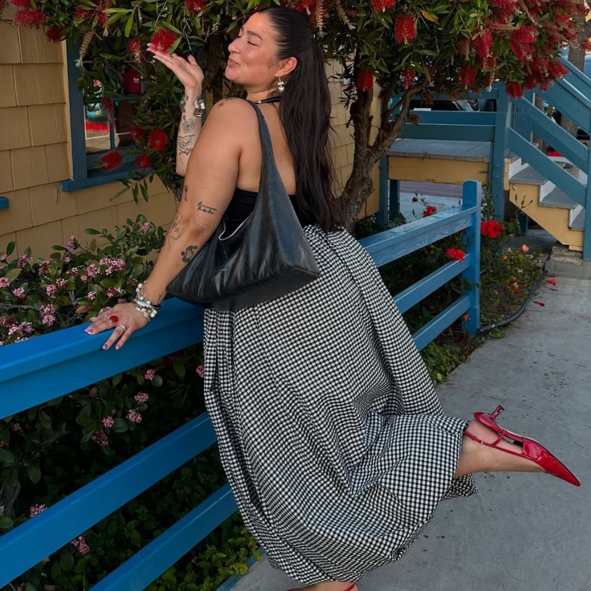 @javiera wears a gingham maxi skirt, black halterneck top, red slingback kitten heels and a black leather tote bag