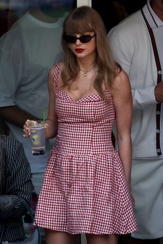 Taylor Swift attends the US open in a gingham reformation dress