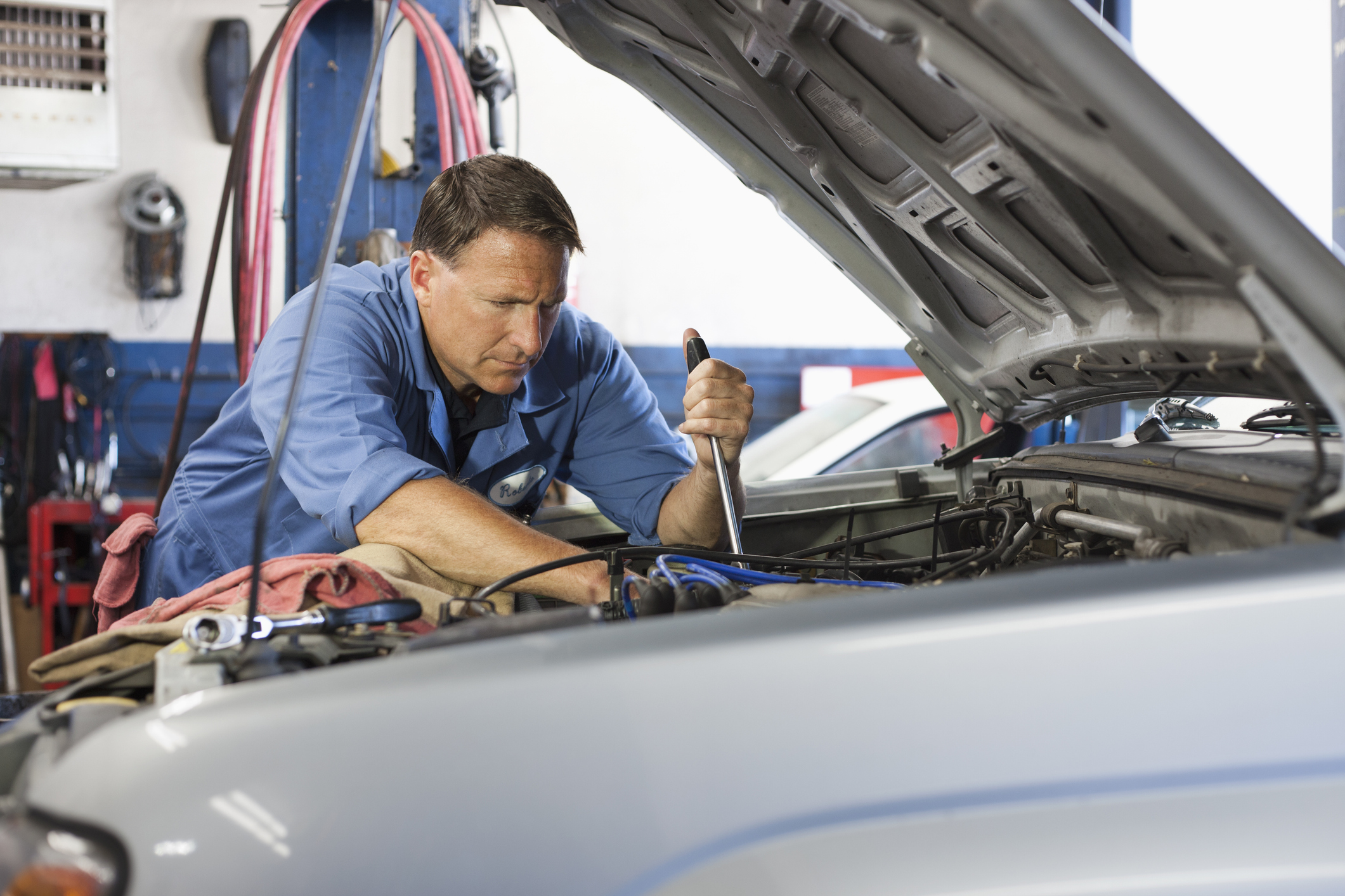 Mechanic checking over a vehicle.