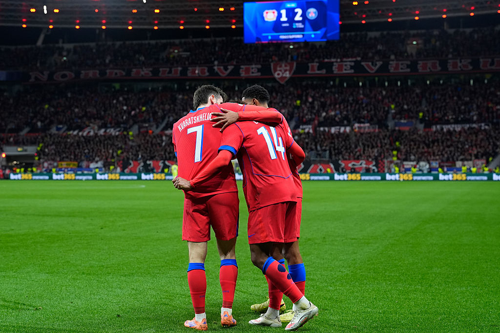 Desire Doue #14 of Paris Saint-Germain F.C. celebrates with the teammates Khvicha Kvaratskhelia #7 of Paris Saint-Germain F.C. after scoring during the UEFA Champions League 2025/26 Phase match between Bayer 04 Leverkusen and Paris Saint Germain (PSG) on October 21, 2025 in BayArena, Germany.