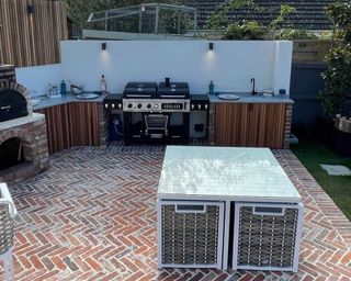 outdoor kitchen with red brick flooring