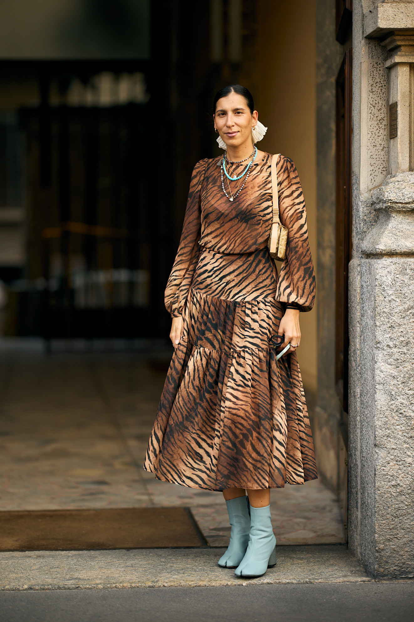 woman wearing leopard print dress and blue heels