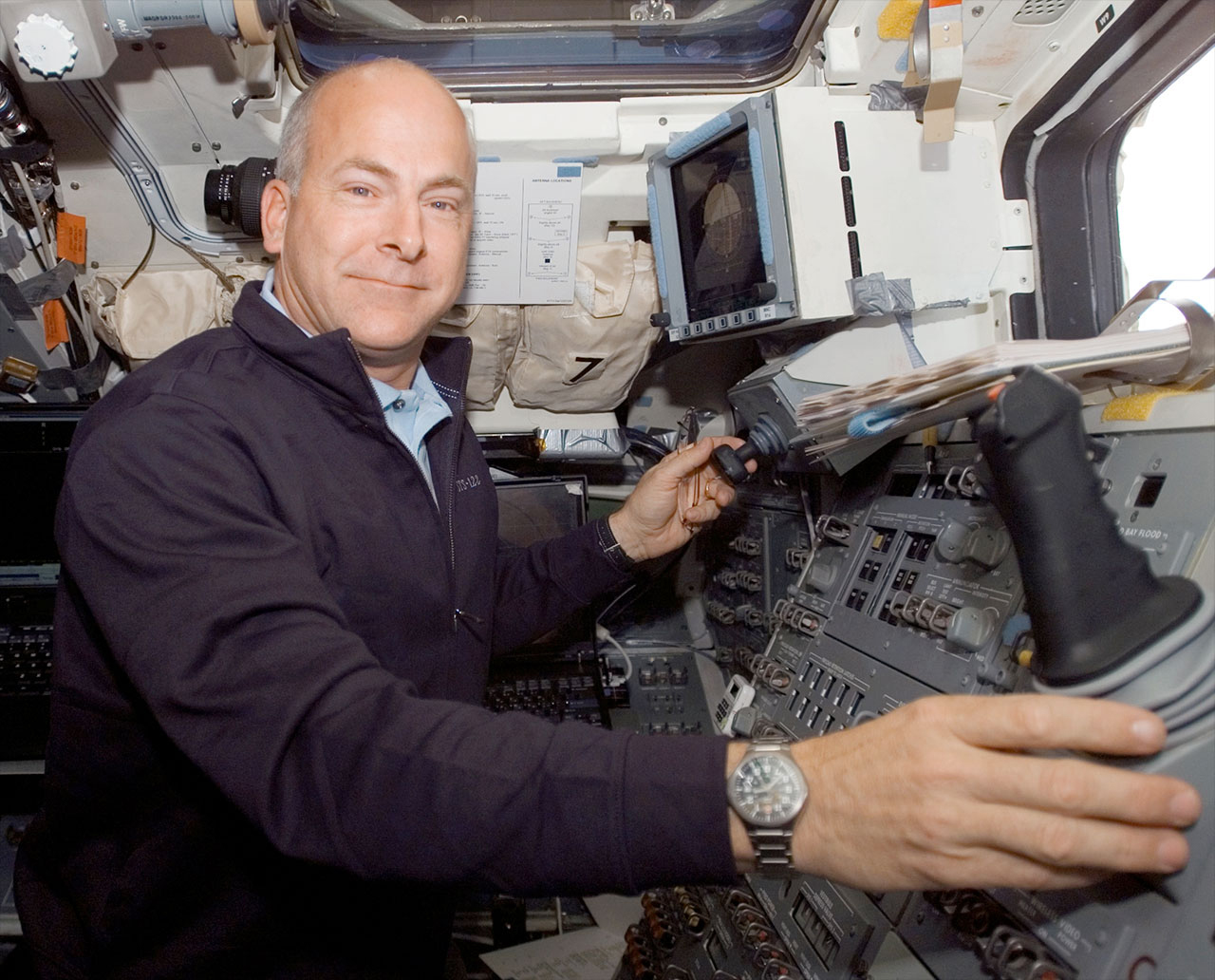 Astronaut Alan Poindexter works on the aft flight deck of space shuttle Atlantis during his first spaceflight in 2008. 