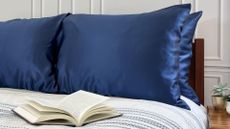 Dark blue copper-infused pillowcases from Copper North on a bed