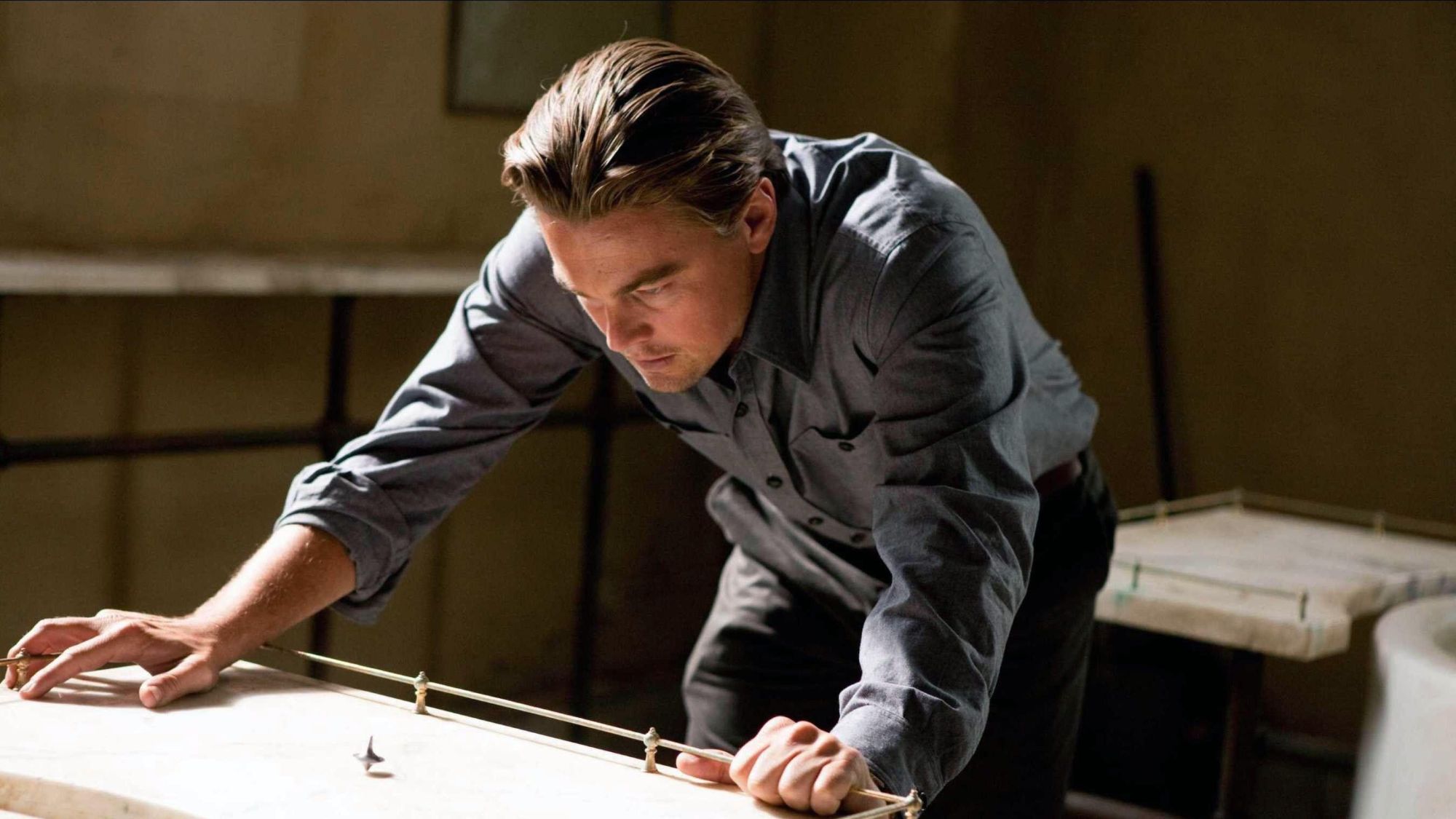 Leonardo DiCaprio watches a top spin in Inception