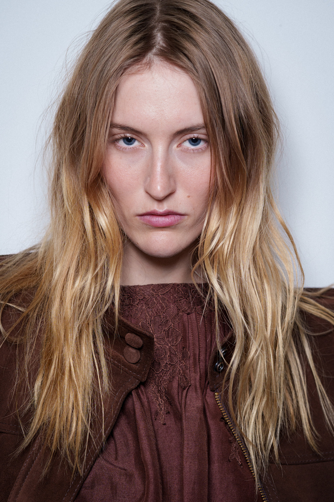 A model with their hair cut into a butterfly cut.