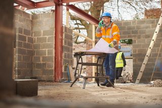 project manager on site looking at plans