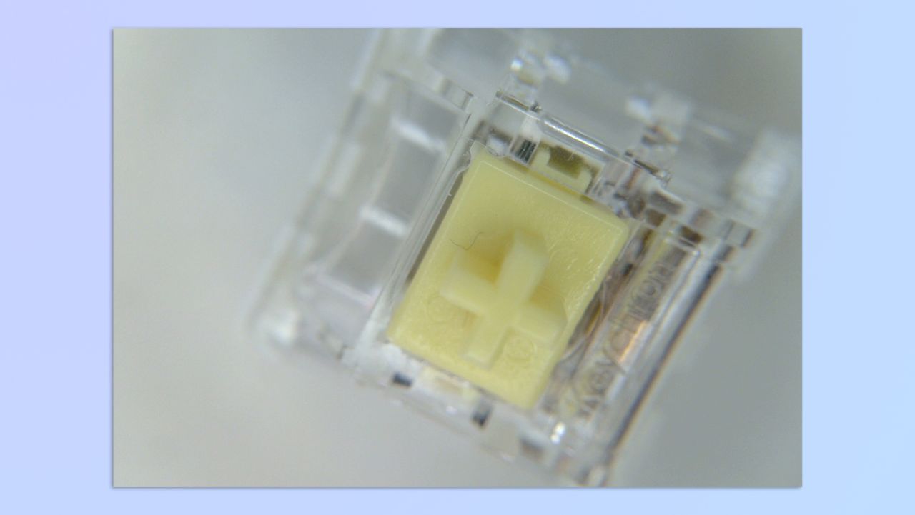 A yellow mechanical switch, shot using a BenQ ideaCam S1 Plus webcam and its 15x macro lens attachment