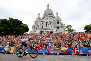 PARIS, FRANCE - AUGUST 03: Remco Evenepoel of Team Belgium attacks in the breakaway passing by the Basilica of the Sacre Coeur during the Men's Road Race on day eight of the Olympic Games Paris 2024 at trocadero on August 03, 2024 in Paris, France. (Photo by Alex Broadway/Getty Images)