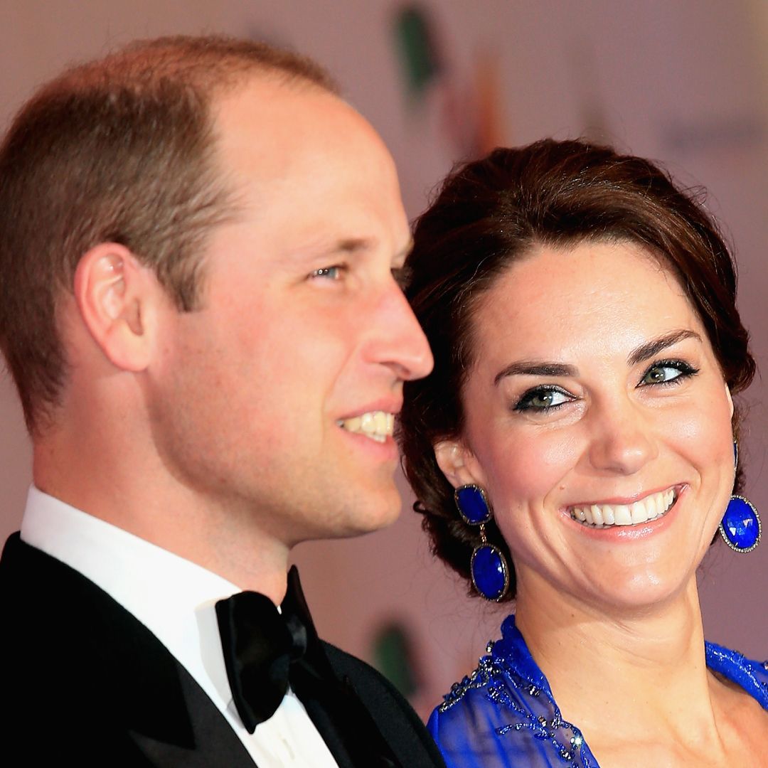 Prince William wearing a tux and Kate Middleton wearing a blue gown in Mumbai