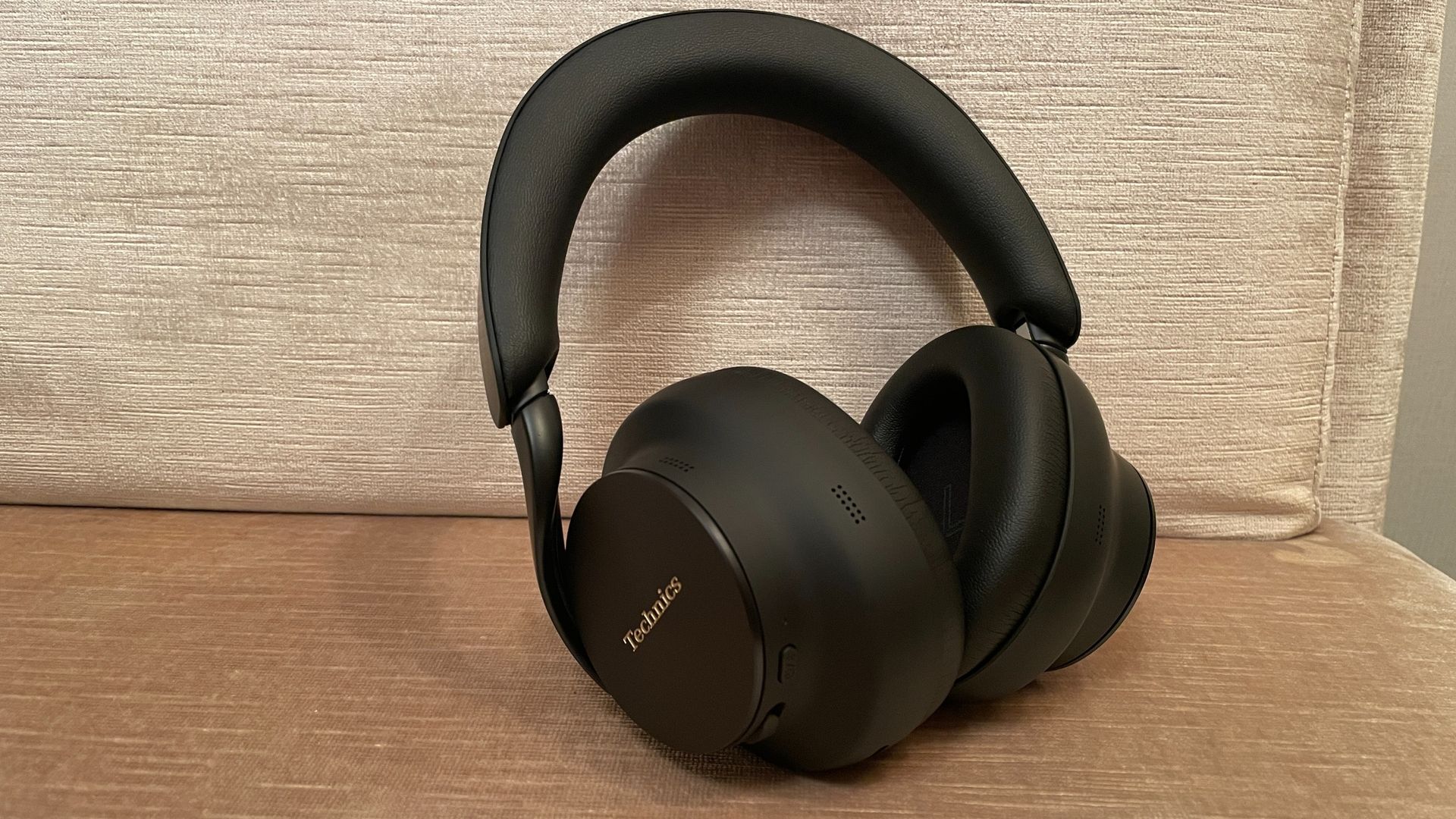 Technics EAH-A1000 in black, in a Tokyo hotel room with the skyline visible