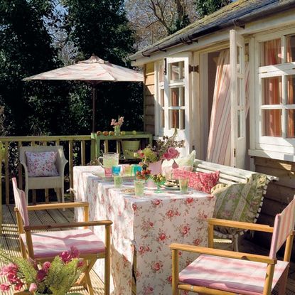 wooden house gallery with dinning table and chairs