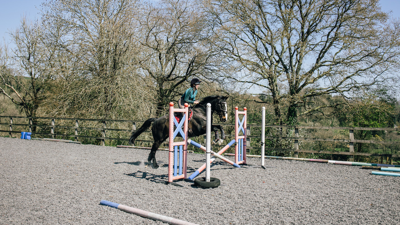 Rider jumping small fence, rebuilding confidence jumping horses