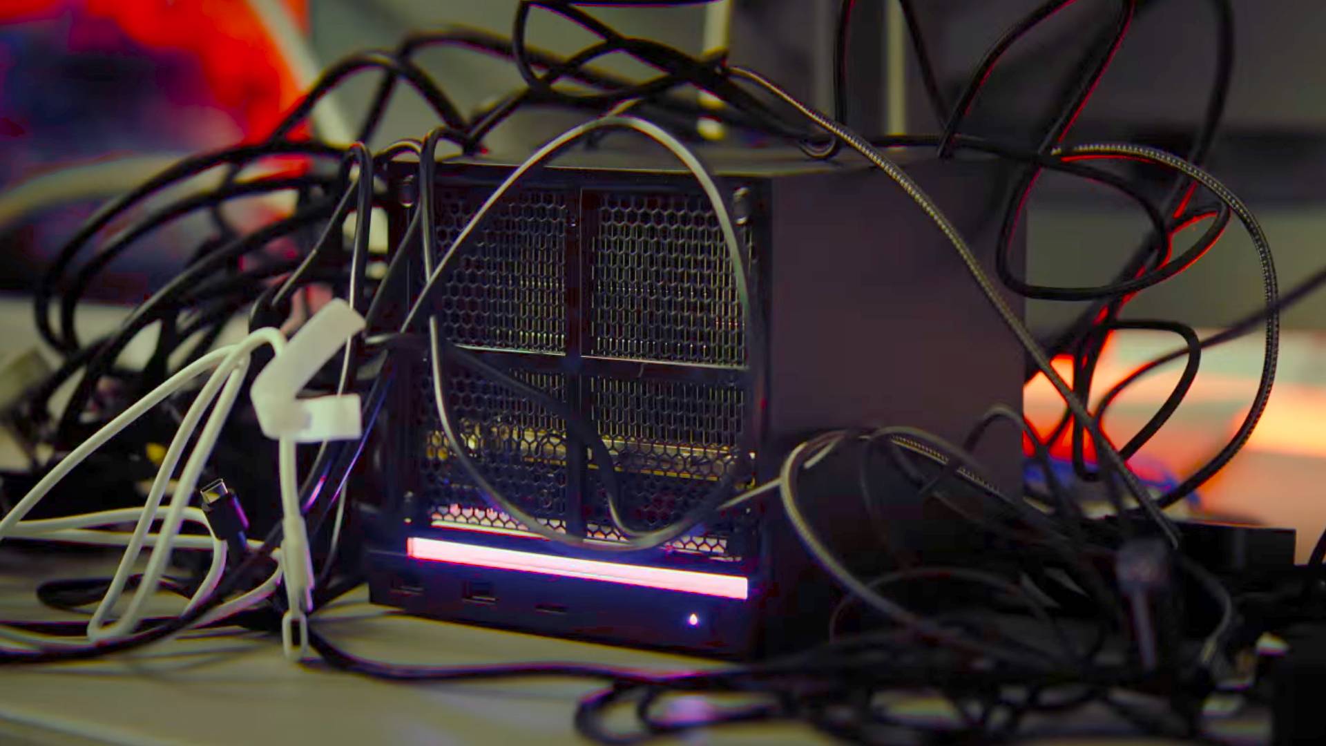 Steam Machine covered in cables with red lights in backdrop.