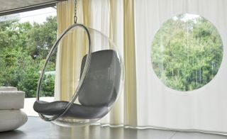Grey coloured hanging armchair with floor curtains