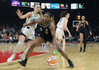 Jackie Young #0 of the Las Vegas Aces is guarded by Sabrina Ionescu #20 of the New York Liberty in the first quarter of Game Two of the 2023 WNBA Playoffs finals at Michelob ULTRA Arena on October 11, 2023