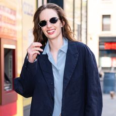 Maya Hawke wears a navy blazer