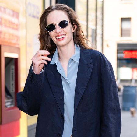 Maya Hawke wears a navy blazer